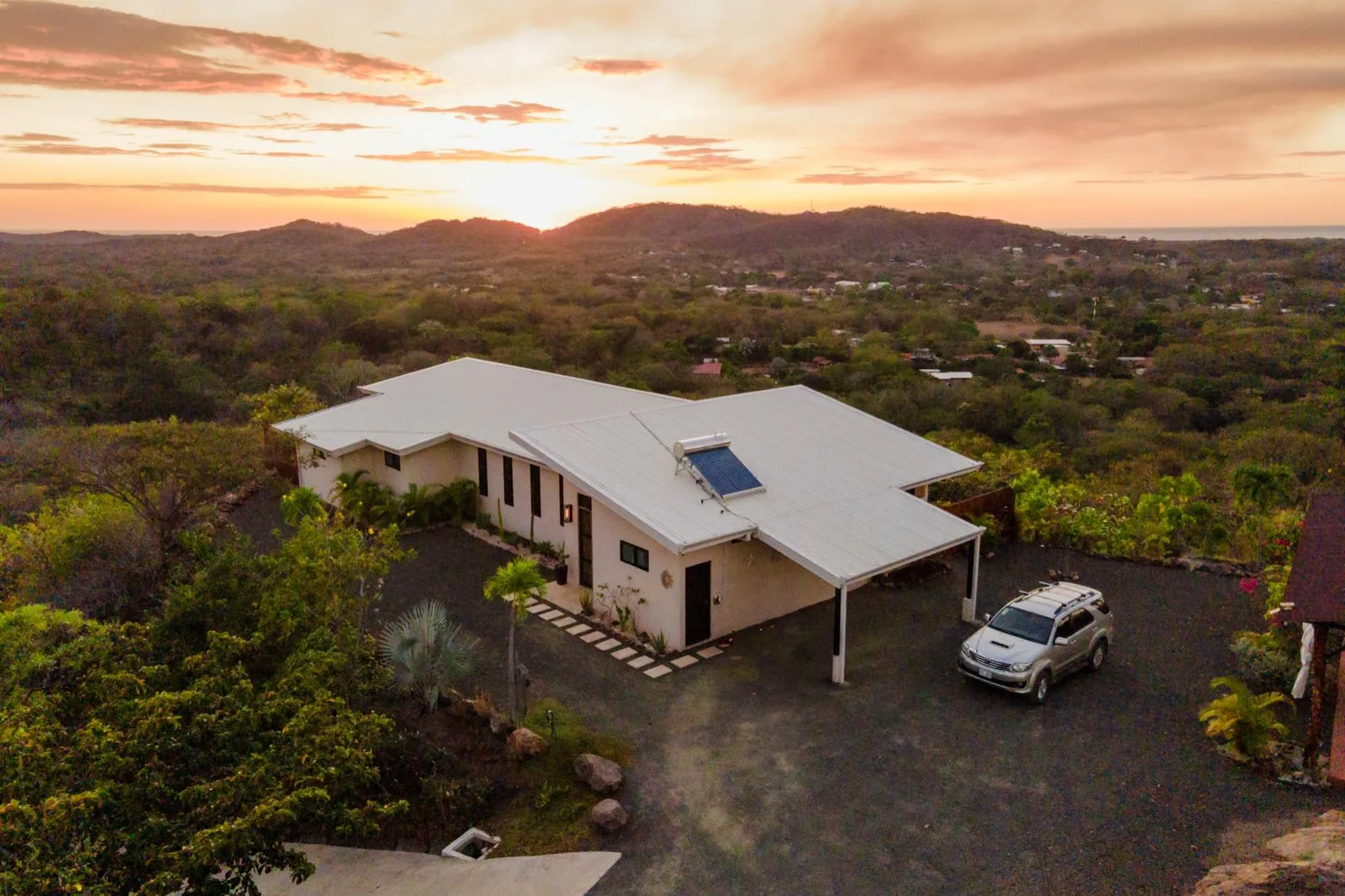 Aerial view of Toltec Estate on its hilltop, with the coast beyond
