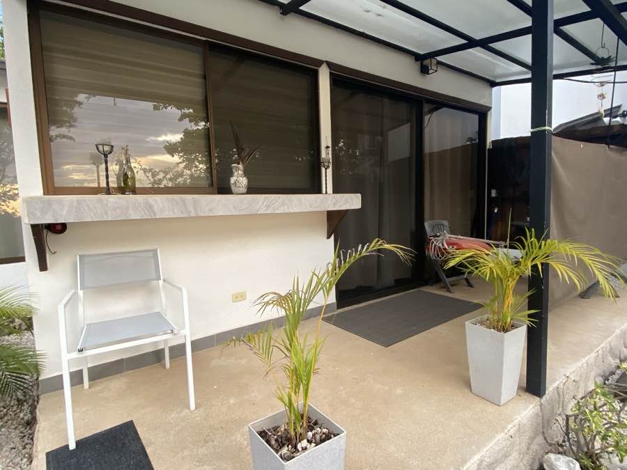 The covered deck off Casa Luna, with a stone bar ledge and a lounge chair