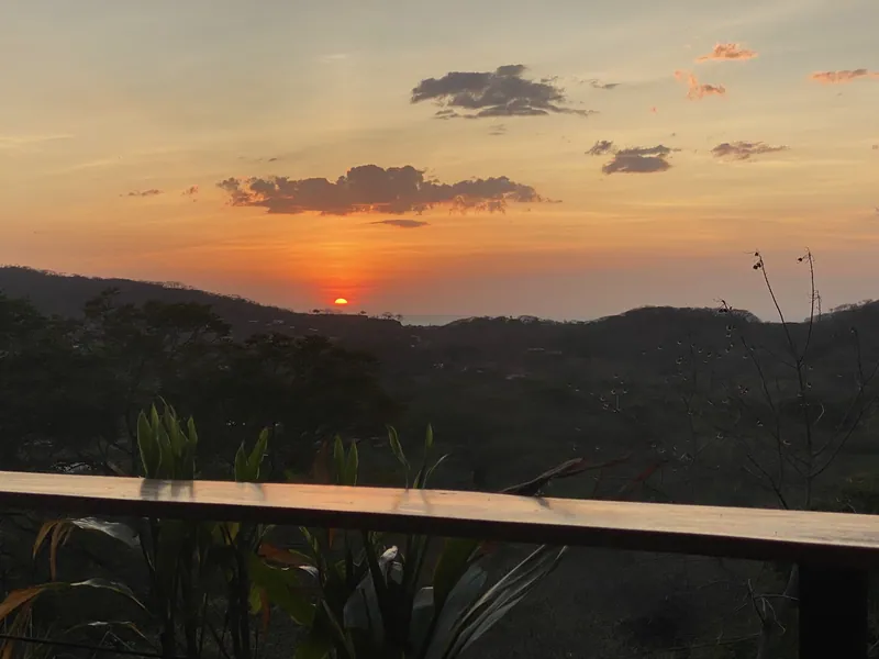 The sun setting toward the Pacific, seen from the deck at Villa Lunax