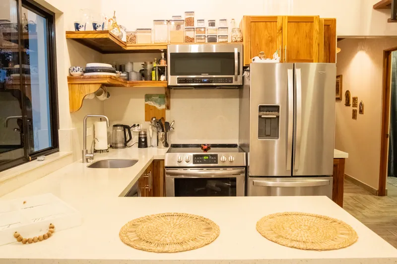 The fully equipped kitchen at Villa Lunax, stainless appliances and quartz counters