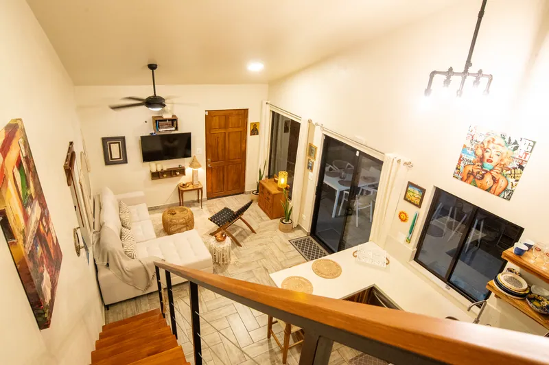 The living room at Villa Lunax seen from the loft, sofa and sliding doors to the deck