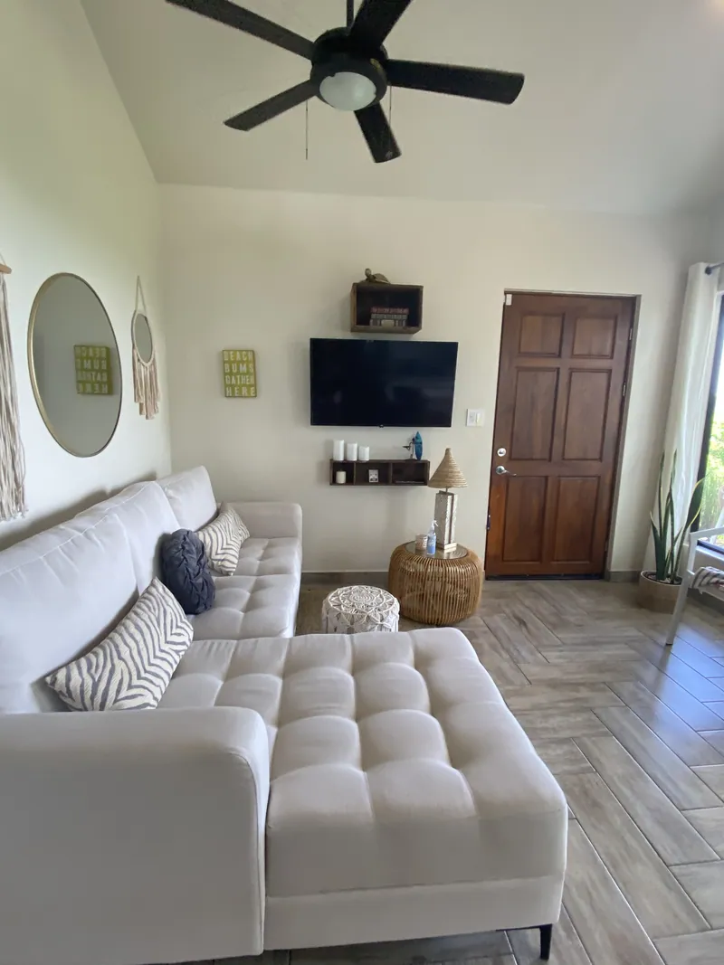 The living room at Villa Lunax, a plush sectional beneath the vaulted ceiling