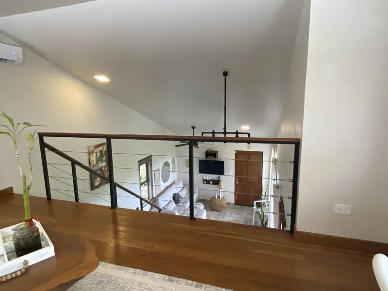 The teak loft railing at Villa Lunax overlooking the great room below
