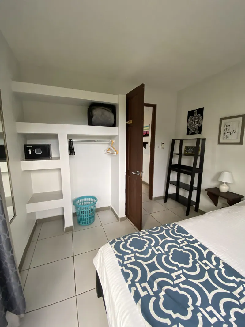 The ground-floor bedroom's built-in closet with shelving and a safe at Villa Sol