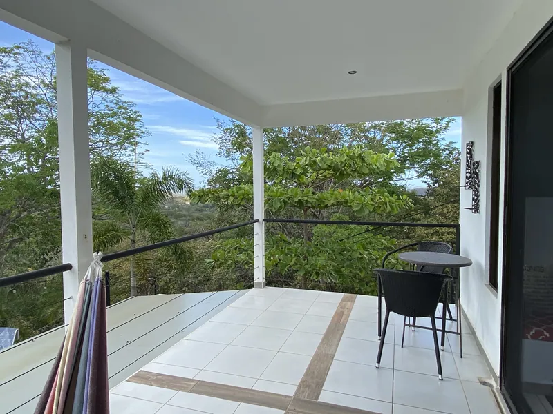 The shaded upstairs terrace at Villa Sol overlooking the treetops