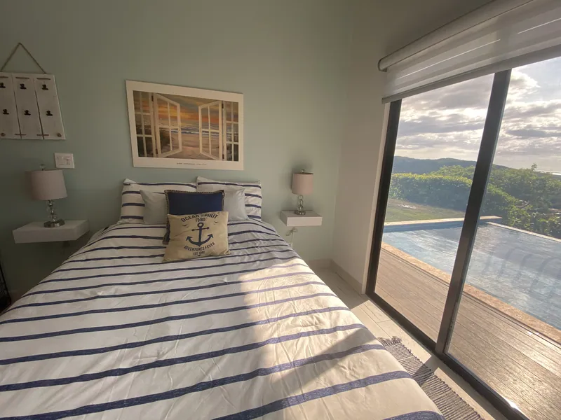The nautical-themed guest bedroom filled with afternoon light