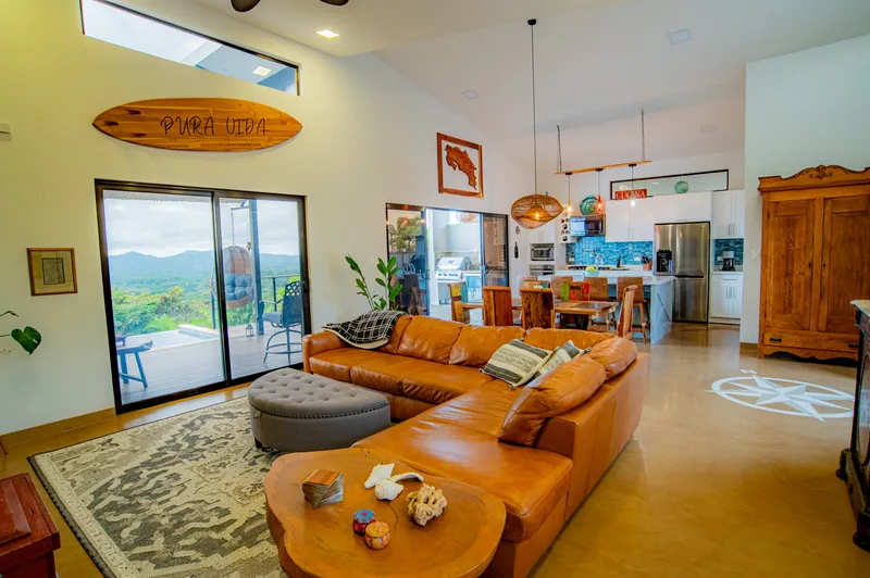 The leather sectional and coffee table of the great room flowing into the kitchen
